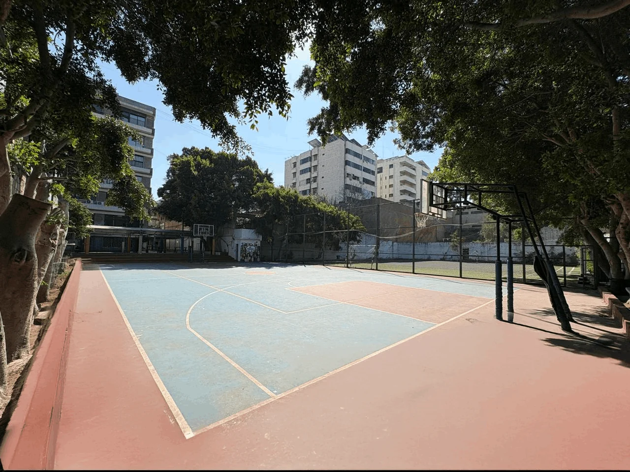 Tree-lined outdoor sports courts at Heritage College